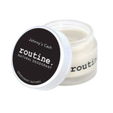 Routine Johnny's Cash vegan deodorant jar opened showing smooth cream texture - beeswax-free plant-based formula with woodsy masculine scent and cruelty-free protection
